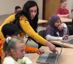 Students and teacher in the classroom using Math Snacks on their computers. 