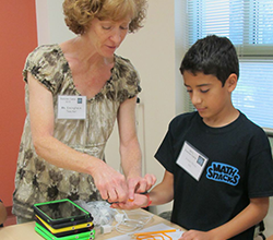Teacher helping with hands-on activity